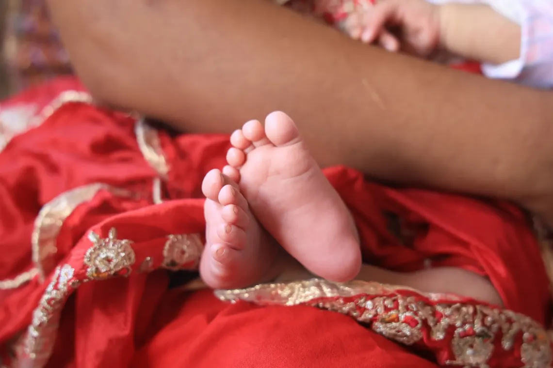 A close-up shot capturing the delicate feet of Nanu Maya's newborn son.
