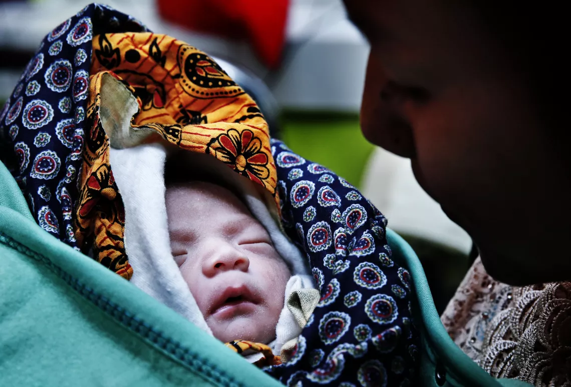 baby wrapped in clothes