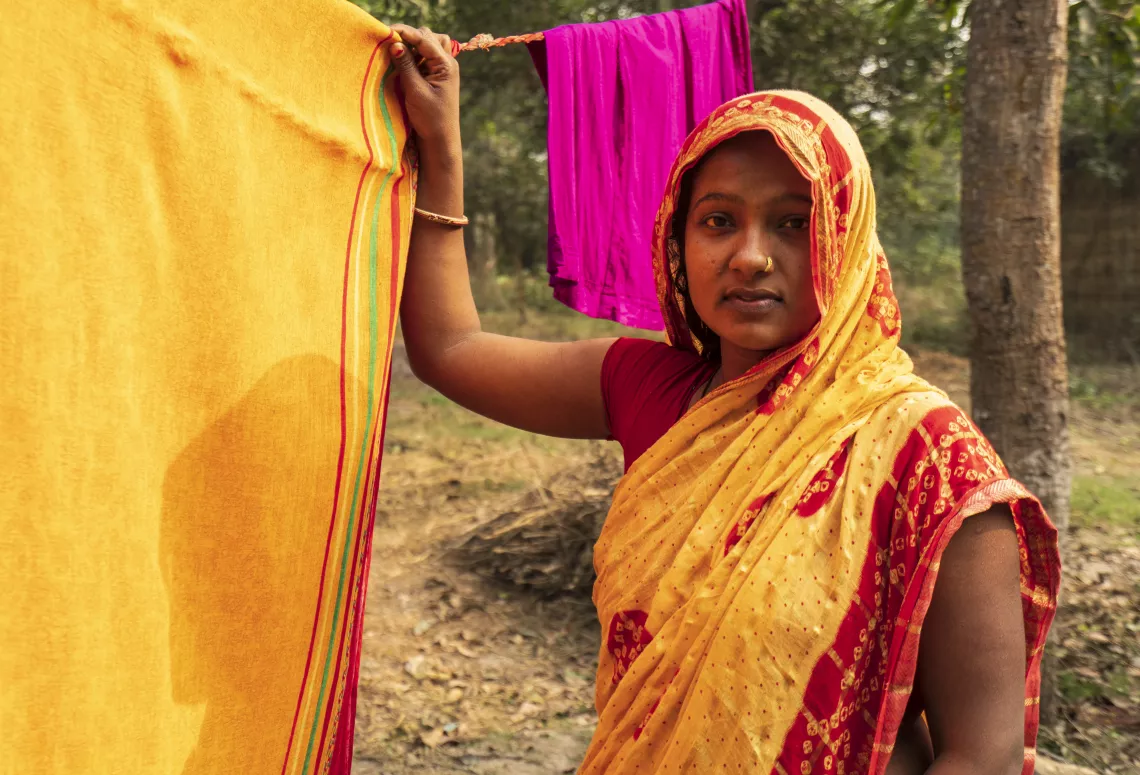 Rakhi Mandal hanging up clothes