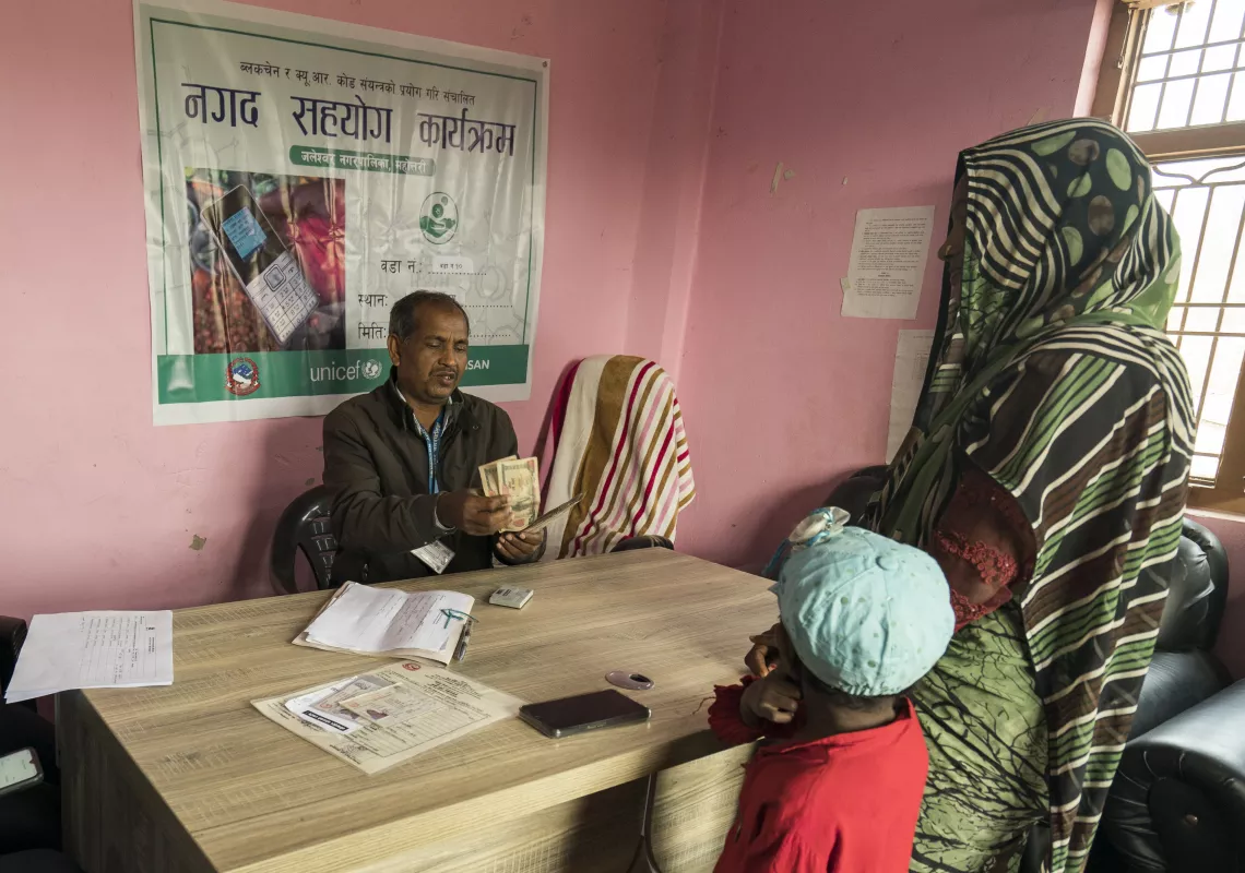 Rakhi and her son at the municipality office receiving the cash grant