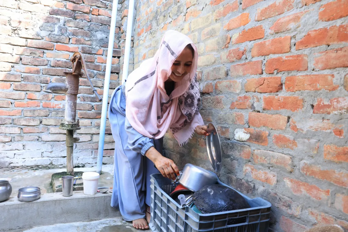 Sabina doing her household chores 