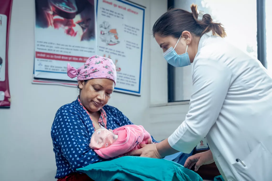 dr smriti helping sarita with her baby