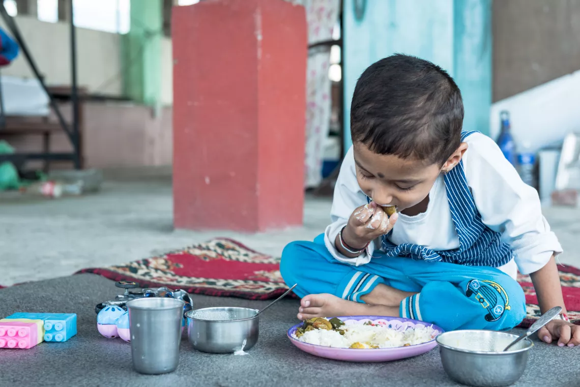 This image shows three year old Aarav eating his lunch