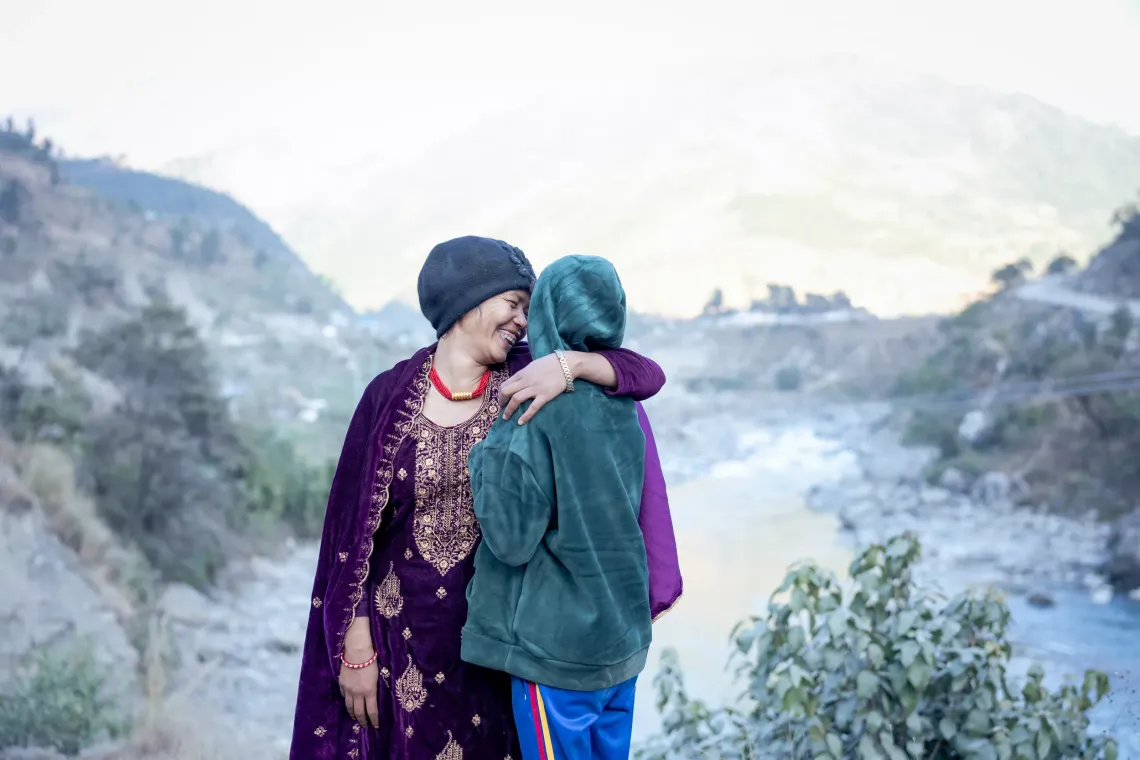 a mother hugs her daughter