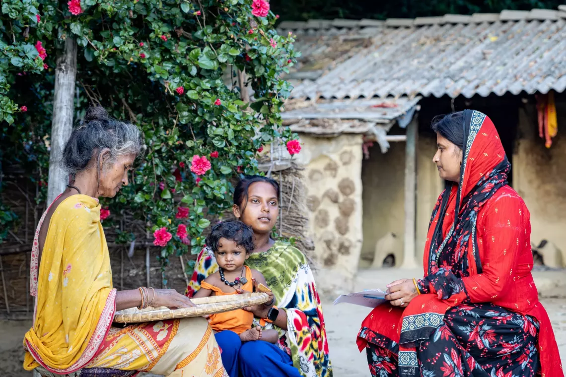 Laxmi and her family talking with the SAGE supervisor