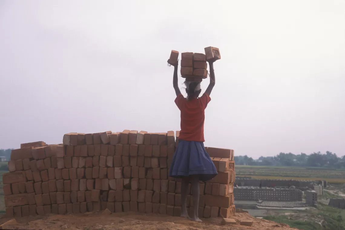 Child collecting bricks