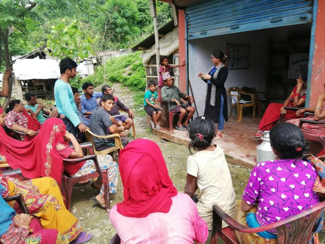 Goma orients community members in Gorkha District on improved water and sanitation practices.