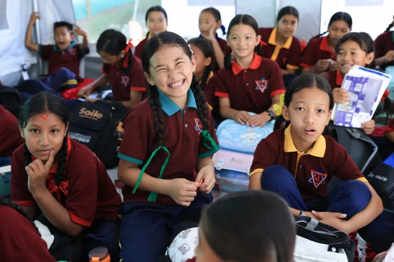 On 22 September 2026, at Tribhuvan Trishuli Secondary School in Nuwakot, Nepal, children return to learning in temporary learning centres or TLCs set up with UNICEF support after devastating floods damaged classrooms and disrupted education in affected communities. 