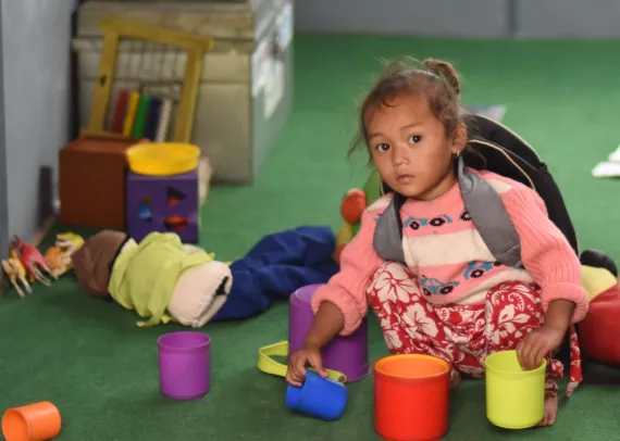 This image shows a young child in her ECD classroom