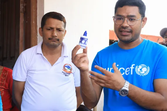 Naresh Nidal, Emergency Officer with UNICEF Nepal, demonstrates how to use water purification products to make water safe for drinking and household use.