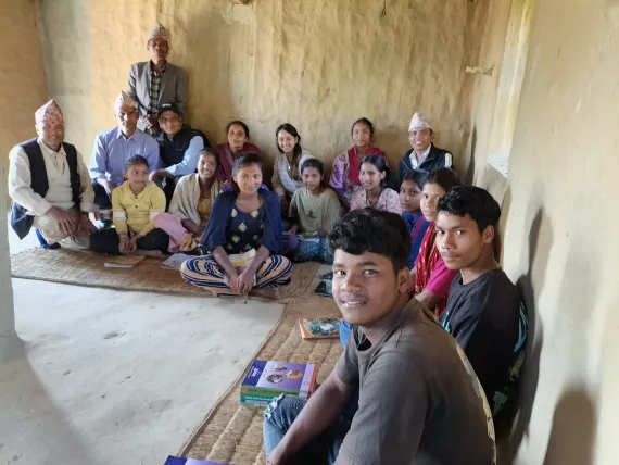 Mahendra surrounded by the ALP facilitators, other ALP learners, and his support system from the local government.