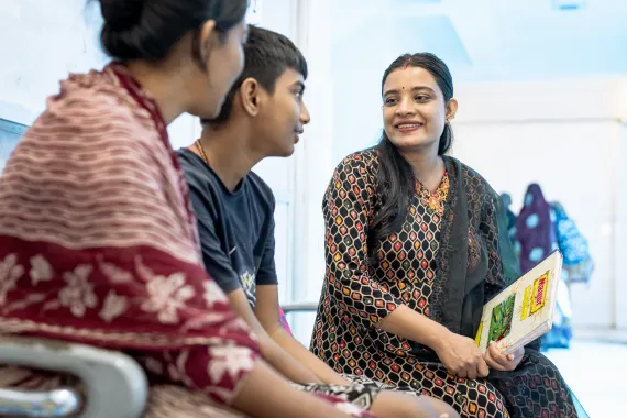 Aakriti meeting with a young patient and his caregiver