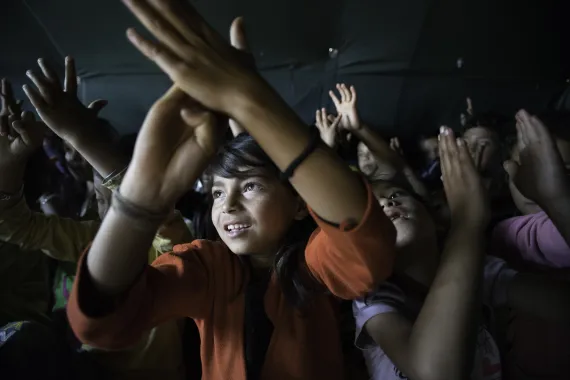 This image shows a group of children clapping their hands