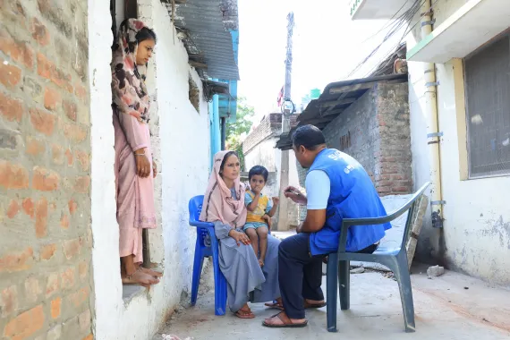 Sabina and her family listening about the multi-hazard risk transfer through household insurance scheme 