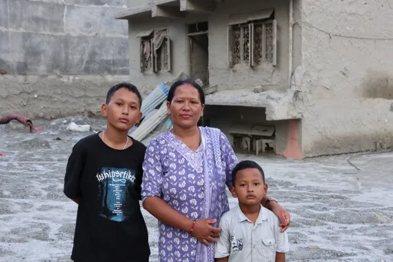 On 21 September 2026, Sita, a mathematics teacher at Tribhuvan Trishuli Secondary School, with her sons in their flood-affected neighbourhood in Nuwakot, Nepal. 