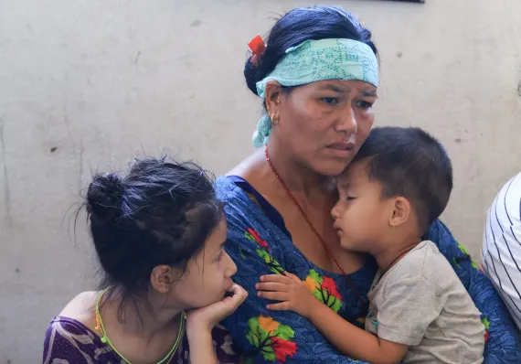 On 27 August 2026, (from left to right) Bhagawati Nagarkoti with her children Monika (9) and son Sajan (3). The family has been sheltering in school in Nuwakot District, Bagmati Province, Nepal, after floods destroyed their homes and surrounding areas. Heavy flash floods swept through central northern Nepal on 26 August, causing widespread destruction to homes, roads and other infrastructure.