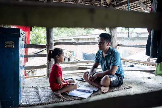 Binay Chaudhary helping his daughter to study