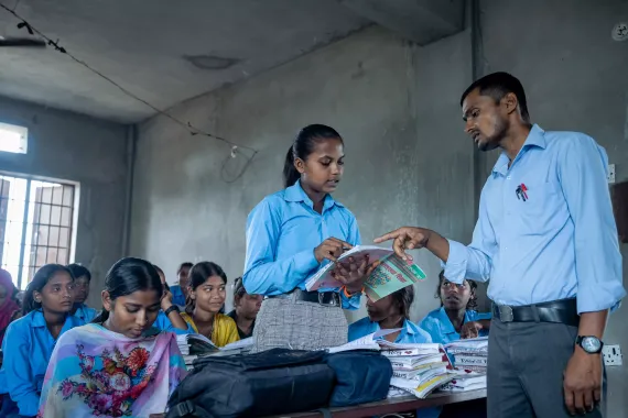 Laxmi reading book in the classroom