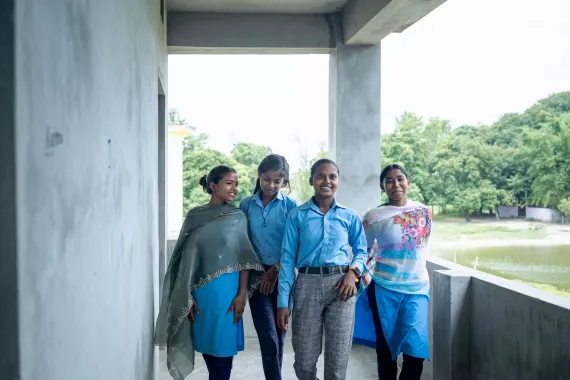 Laxmi and her friends walking in the school balcony