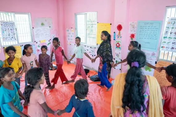 Group of SAGE participants holding hand in walking in circle