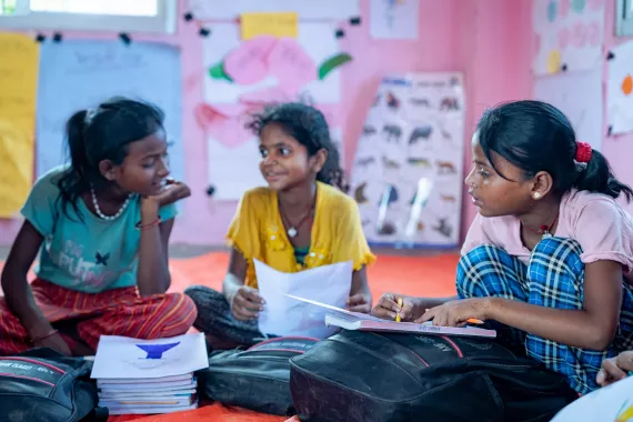 SAGE participants in the classroom smiling and studying