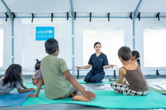 Group First Psychological Aid session with the children in the medical tent set up by UNICEF Nepal.
