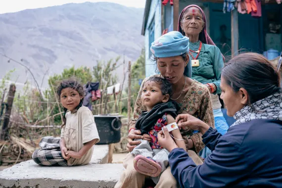 In Tripurasundari Rural Municipality in Dolpa District, health worker Srijana Rokaya and Female Community Health Volunteer Surya Kumari Shahi visit the home of young mother Lal Kumari Ukheda to check up on her one-year-old son Nirajan. Nirajan was recently diagnosed with severe acute malnutrition and is currently being treated with Ready-To-Use Therapeutic Food (RUTF), supplies of which have been provided by the US Government to Nepal through UNICEF.