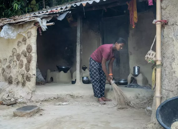 Laxmi sweeping in front of her house