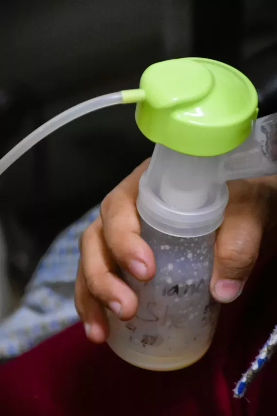 Prajina showing the breastmilk she has collected