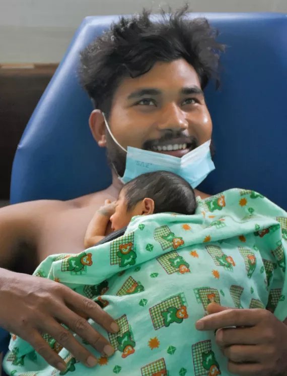 Ajay Chaudhary practicing Kangaroo Mother Care with his newborn son
