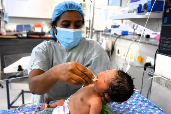 Nursing aide Apsara Bista feeding donated breastmilk to a newborn being treated at the Paropakar Maternity and Women&rsquo;s Hospital. 