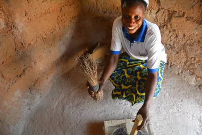 A woman beside a sanitary latrine.