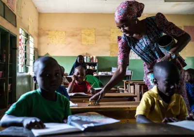A teacher assists her students during classwork