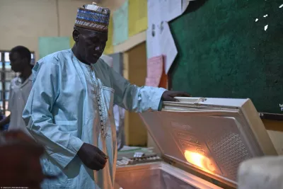 A man opening a refrigerator.