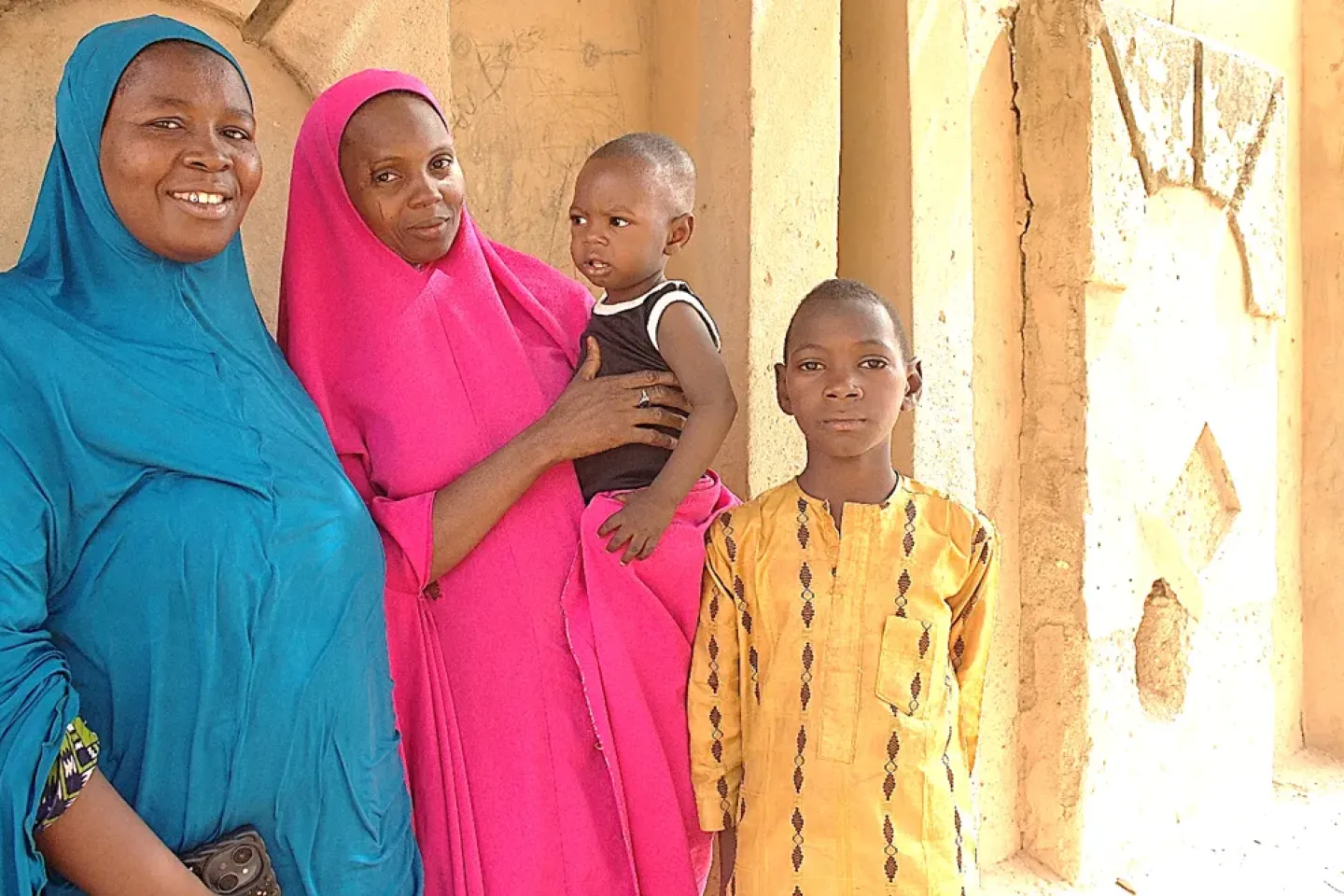 Two women standing with two boys