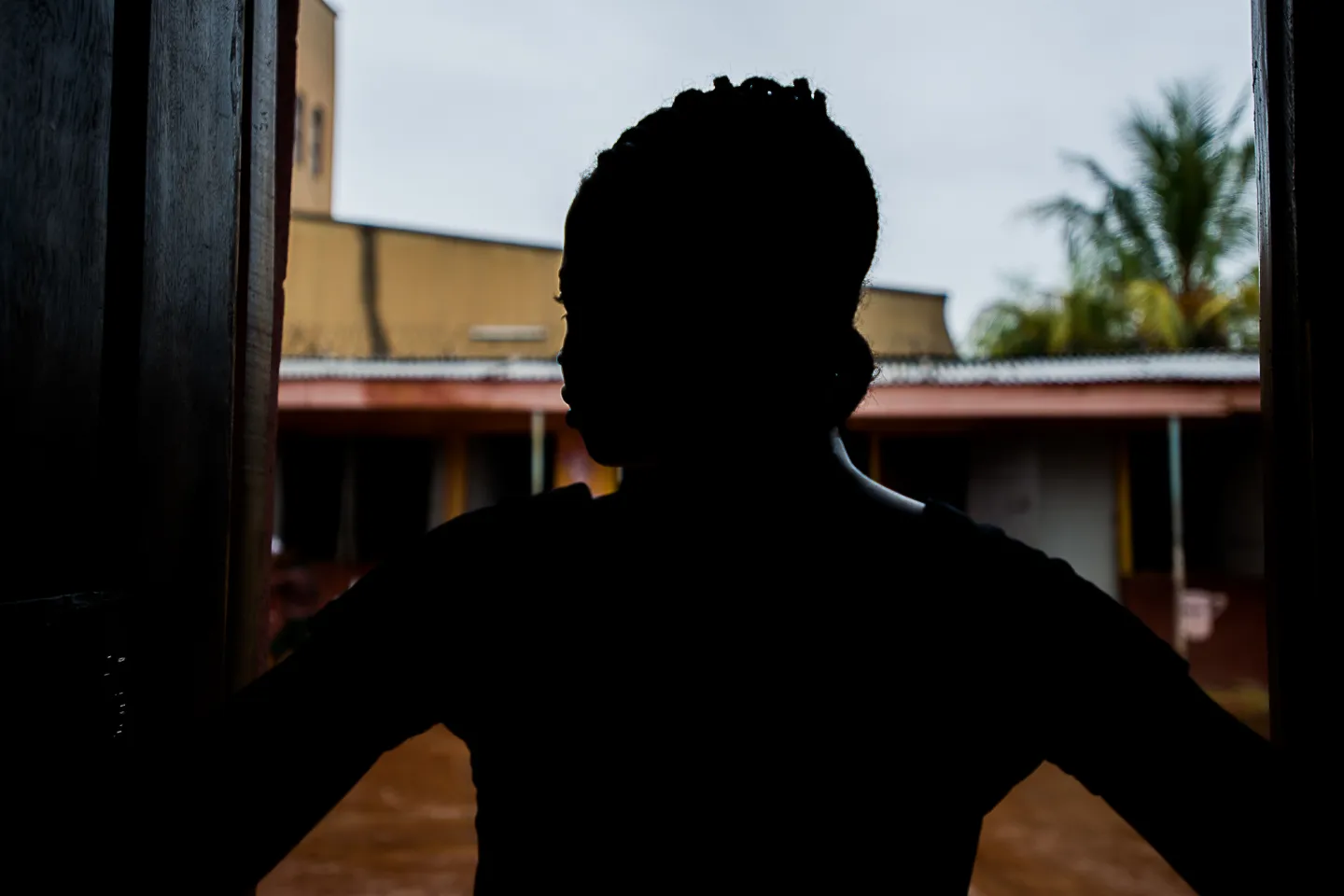 A girl looks out of a window