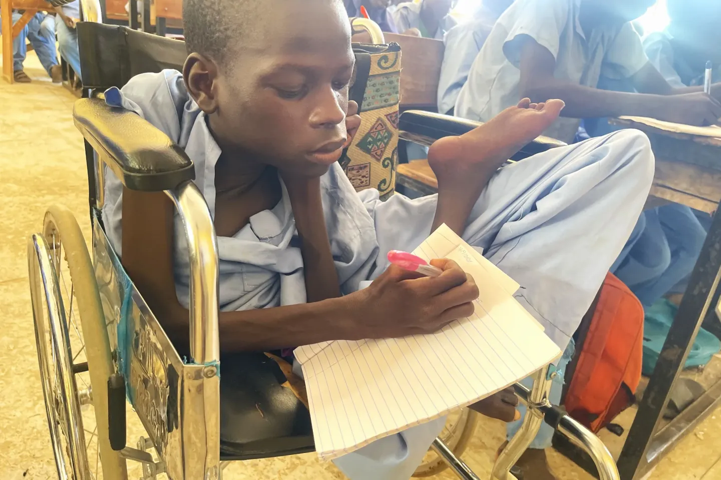 A child with disability learning in class.