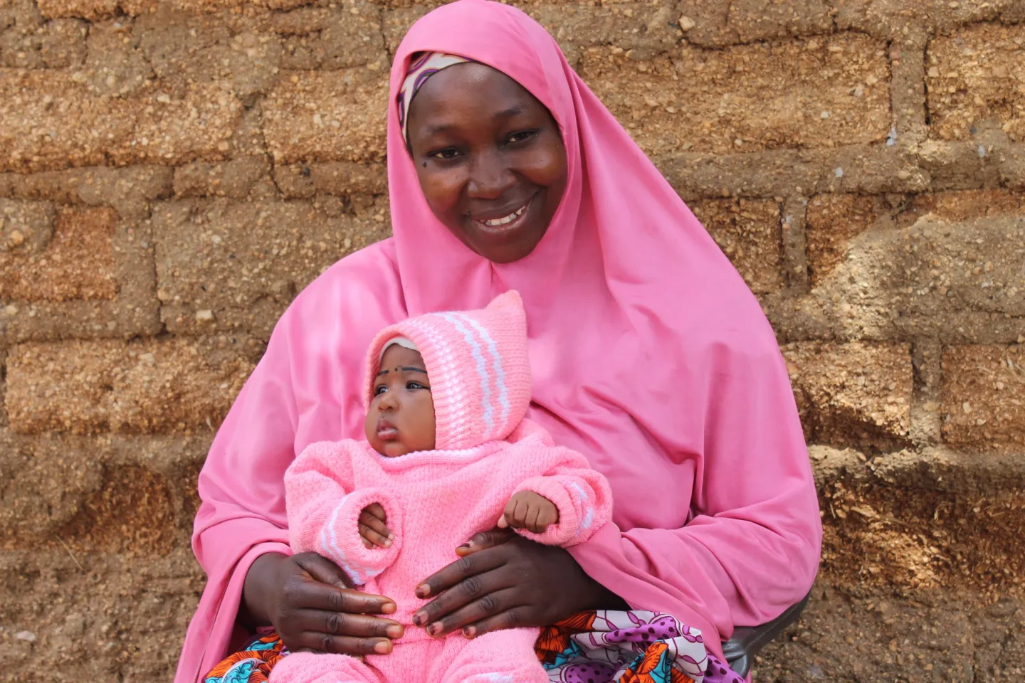 A mother carries her baby on her laps