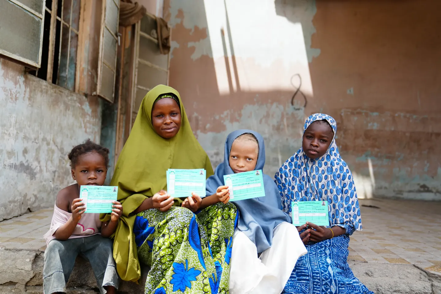 A family holding their vaccination cards