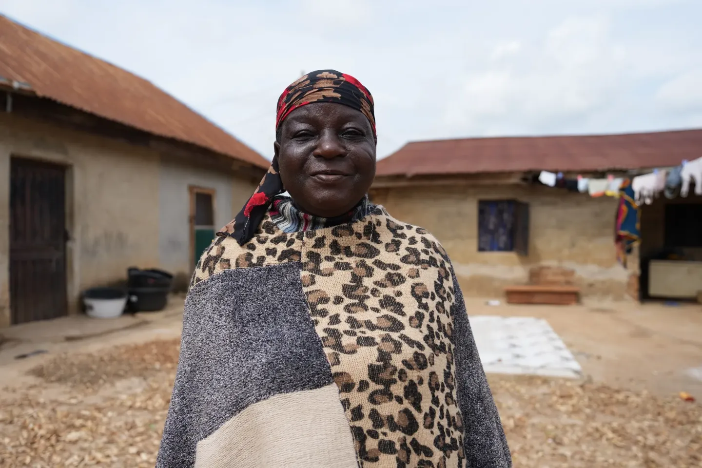 A woman standing in front of her house