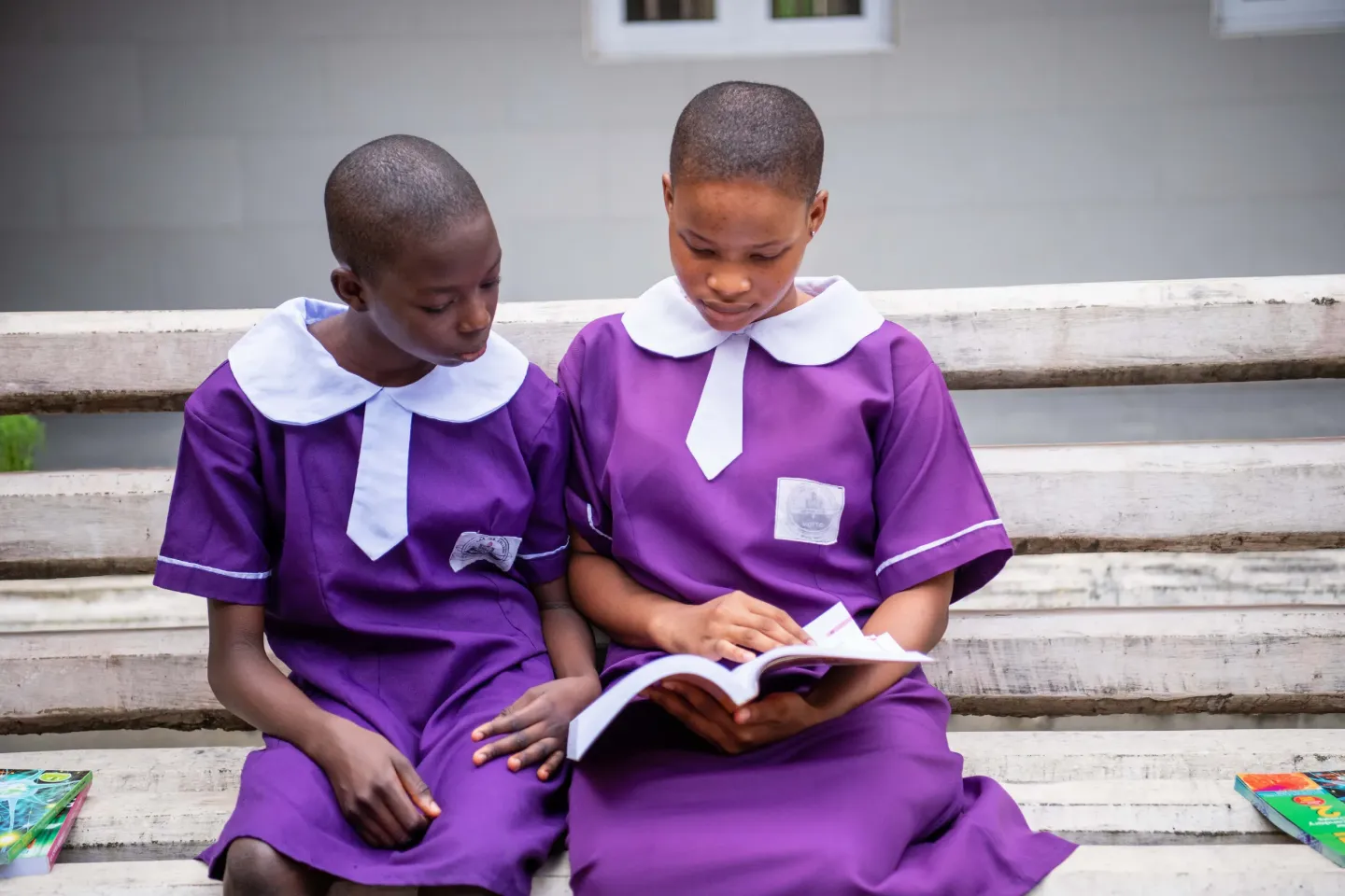 Two girls reading a book