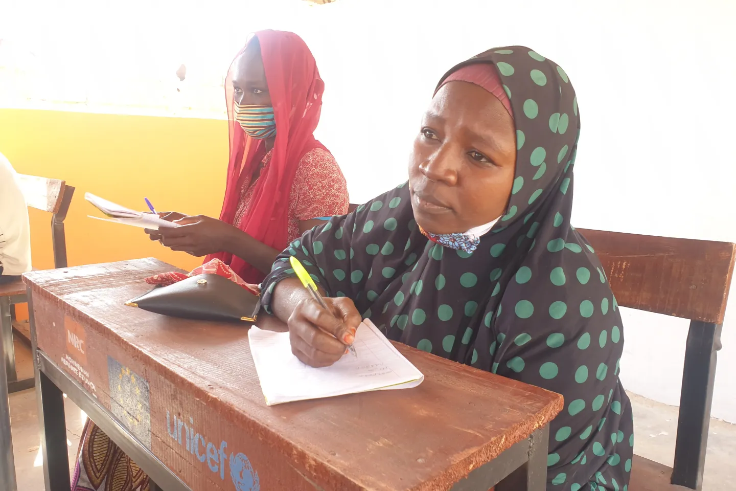 A young lady sitting in a classroom