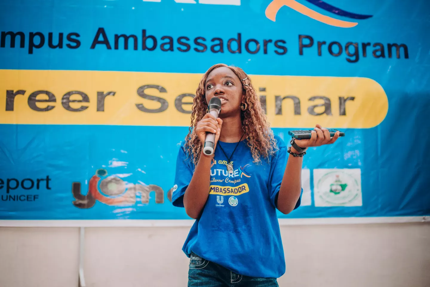 A young woman speaking into a microphone