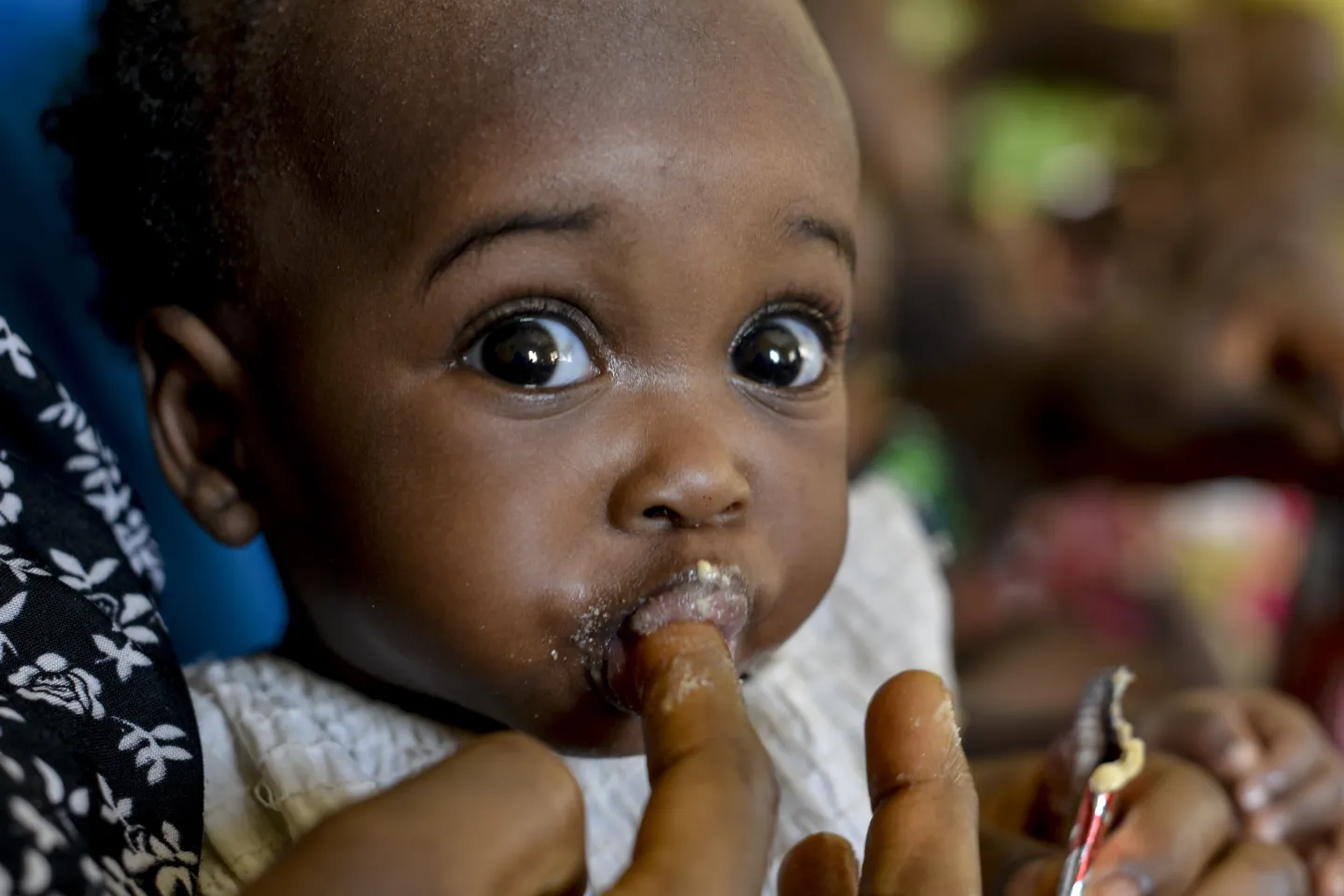 A child being fed with RUTF