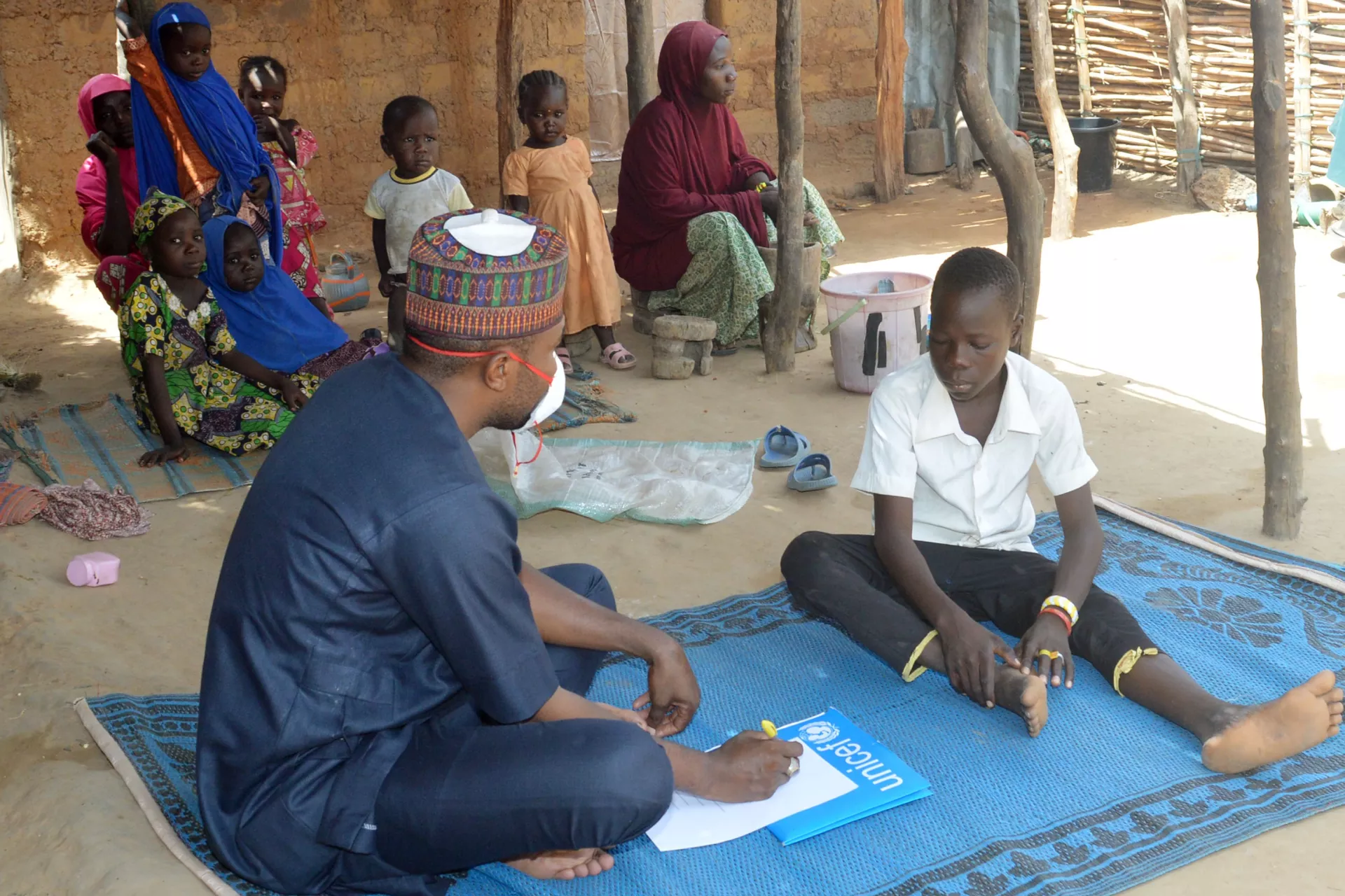 A boy speaking to a social worker