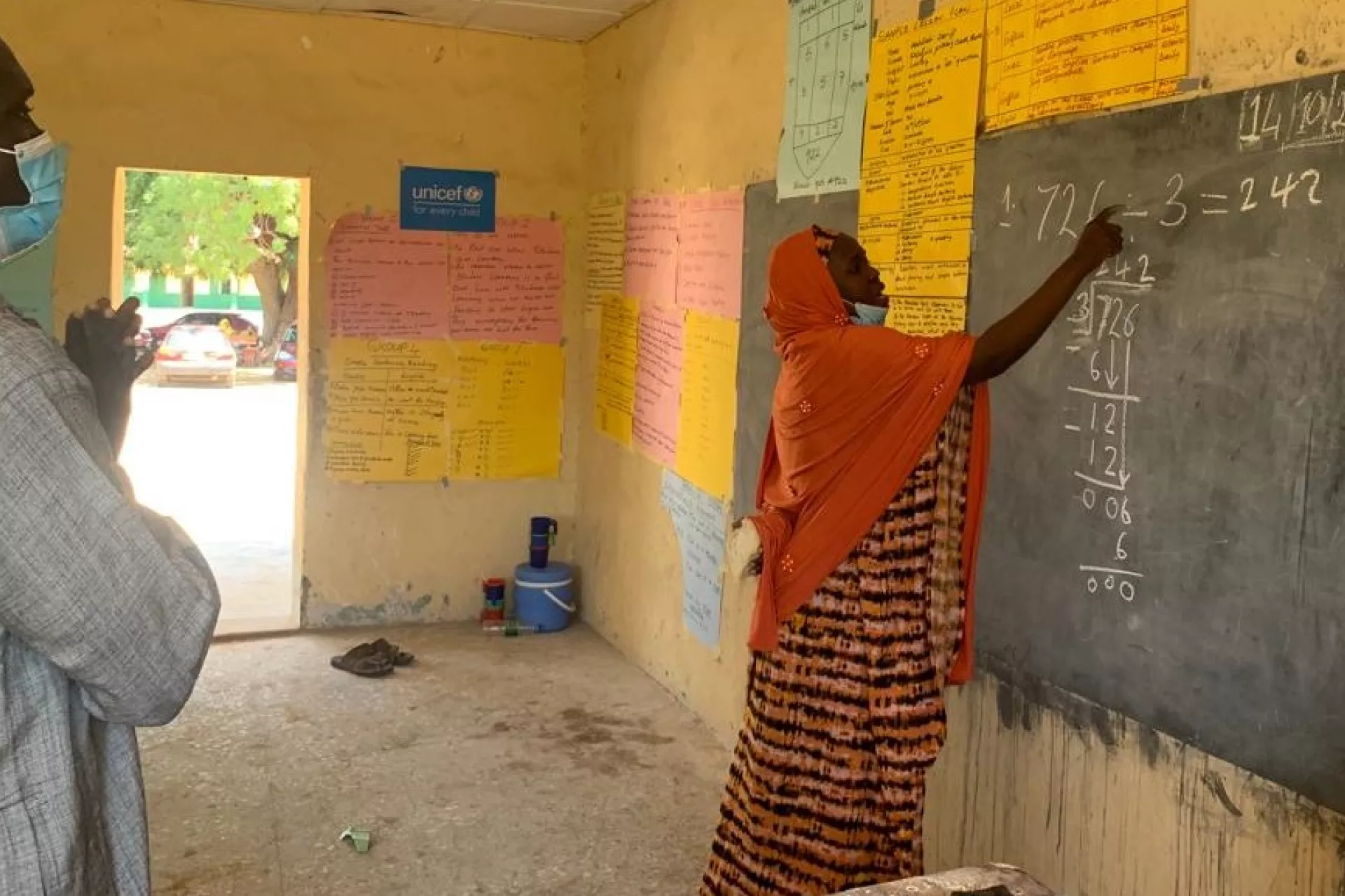 A woman writing on the blackboard