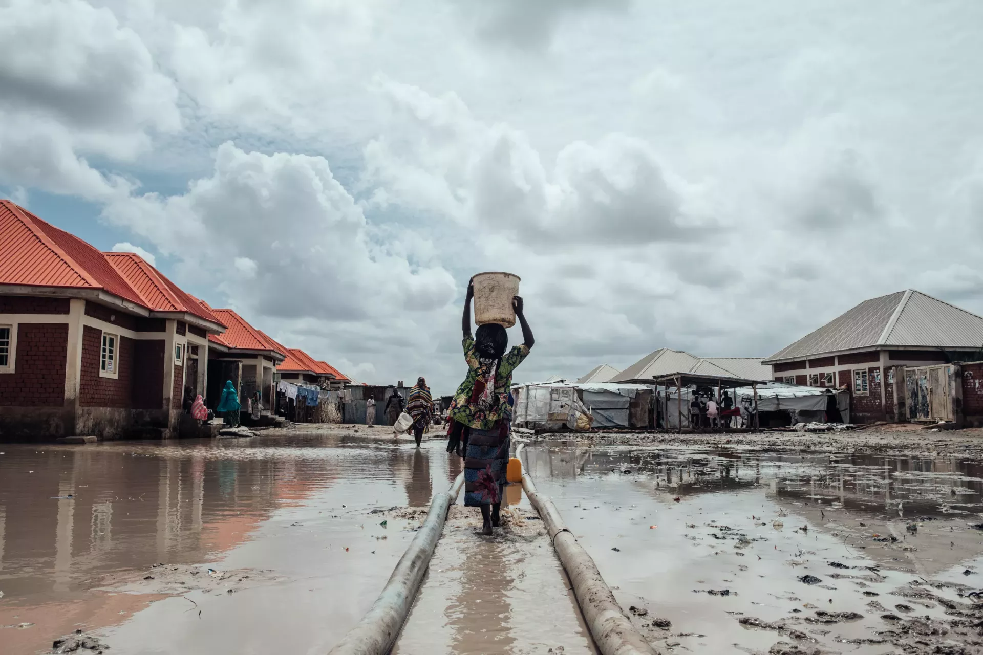 A girl carries water home.