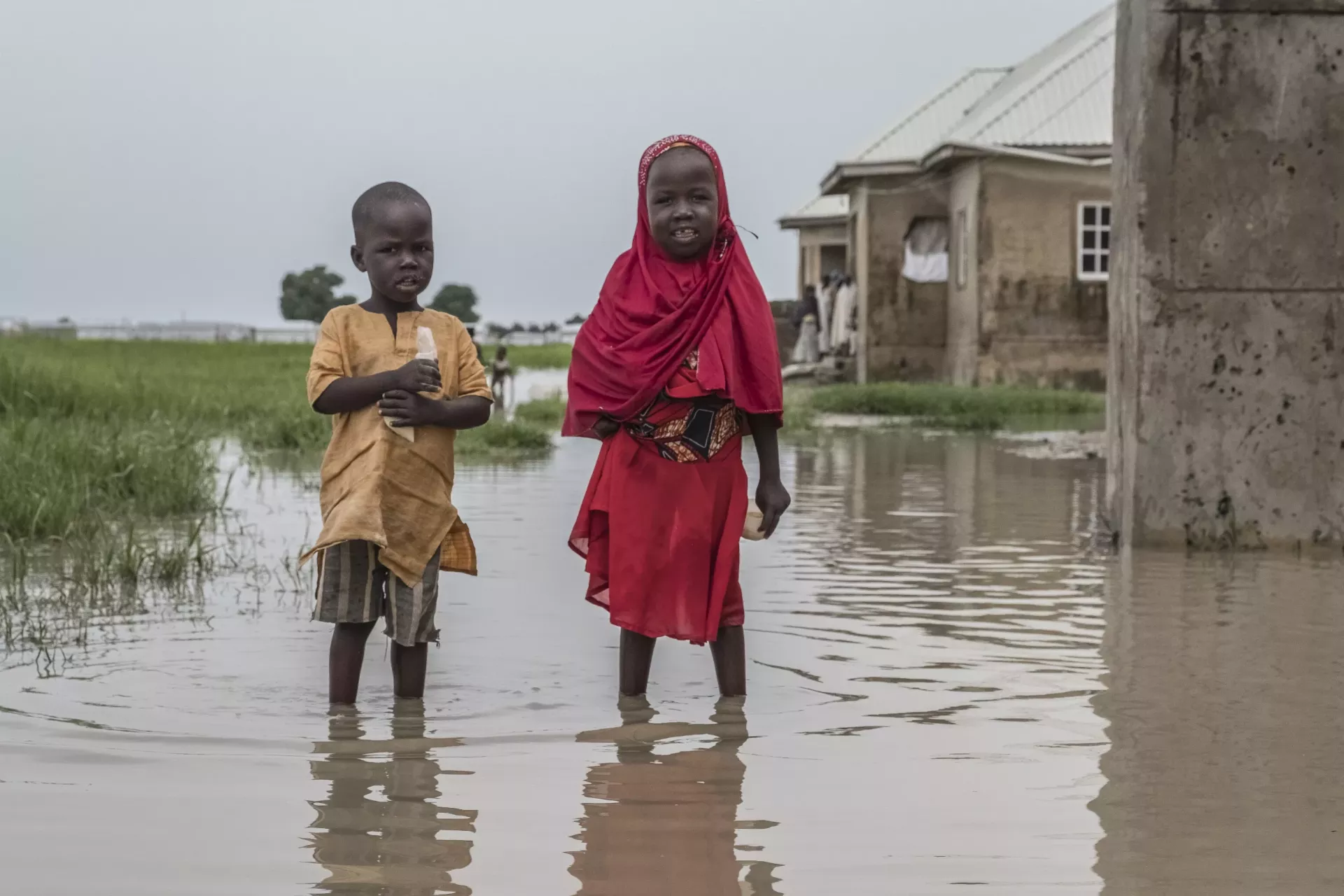 Children standing in a pool of water.