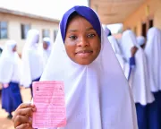 A girl's photo with her vaccination card