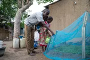 A father and daughter watering their garden